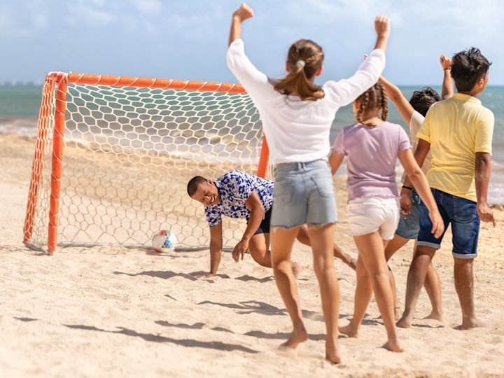 Guests play beach soccer at Hilton Cancún