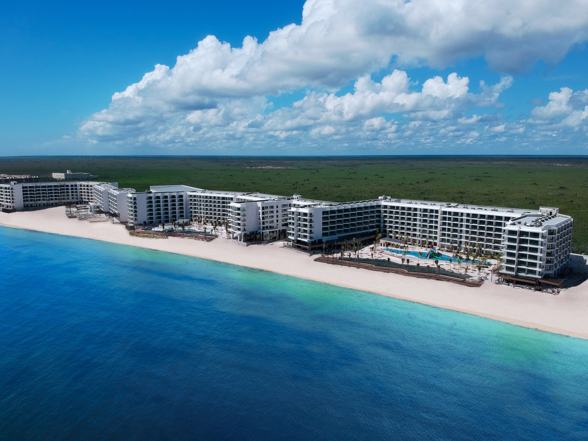 Aerial view of Hilton Cancún, an All-Inclusive Resort, between the Caribbean Sea and green mangroves